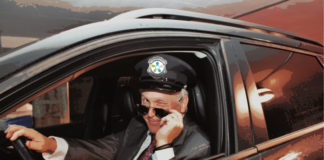 Les agrémentables : avoir la bonne personne Dr Leduc déguisé en chauffeur de limousine, le logo d'Agrément sur sa casquette. Il a baissé ses lunettes de soleil et fait un clin d'oeil.