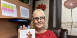 Femme blonde avec chandail rouge qui tient un pamphlet sur la retraite